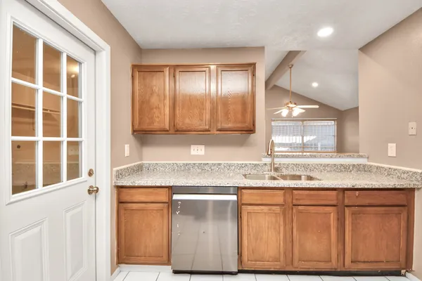 a bathroom with a granite countertop sink a vanity and a large mirror