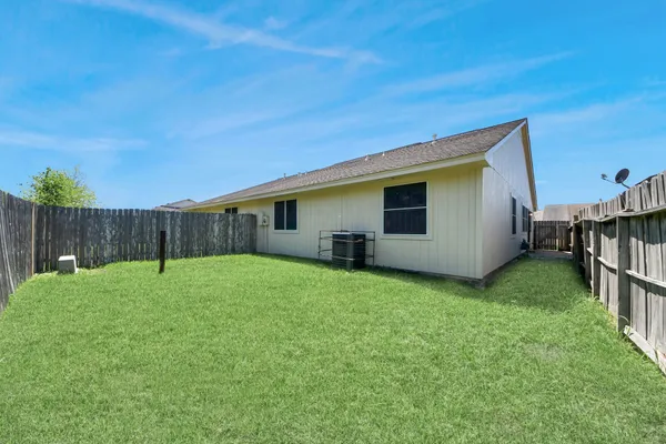 a backyard of a house with table and chairs