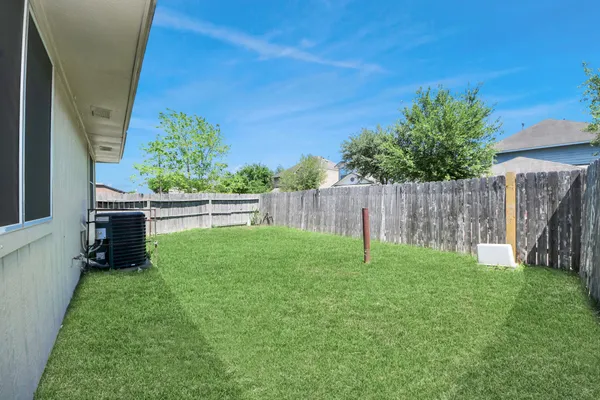 a view of a backyard with a garden and deck