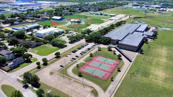 an aerial view of a pool yard tennis courts and ocean view