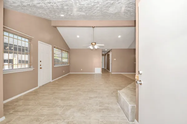 a view of a livingroom with a chandelier fan