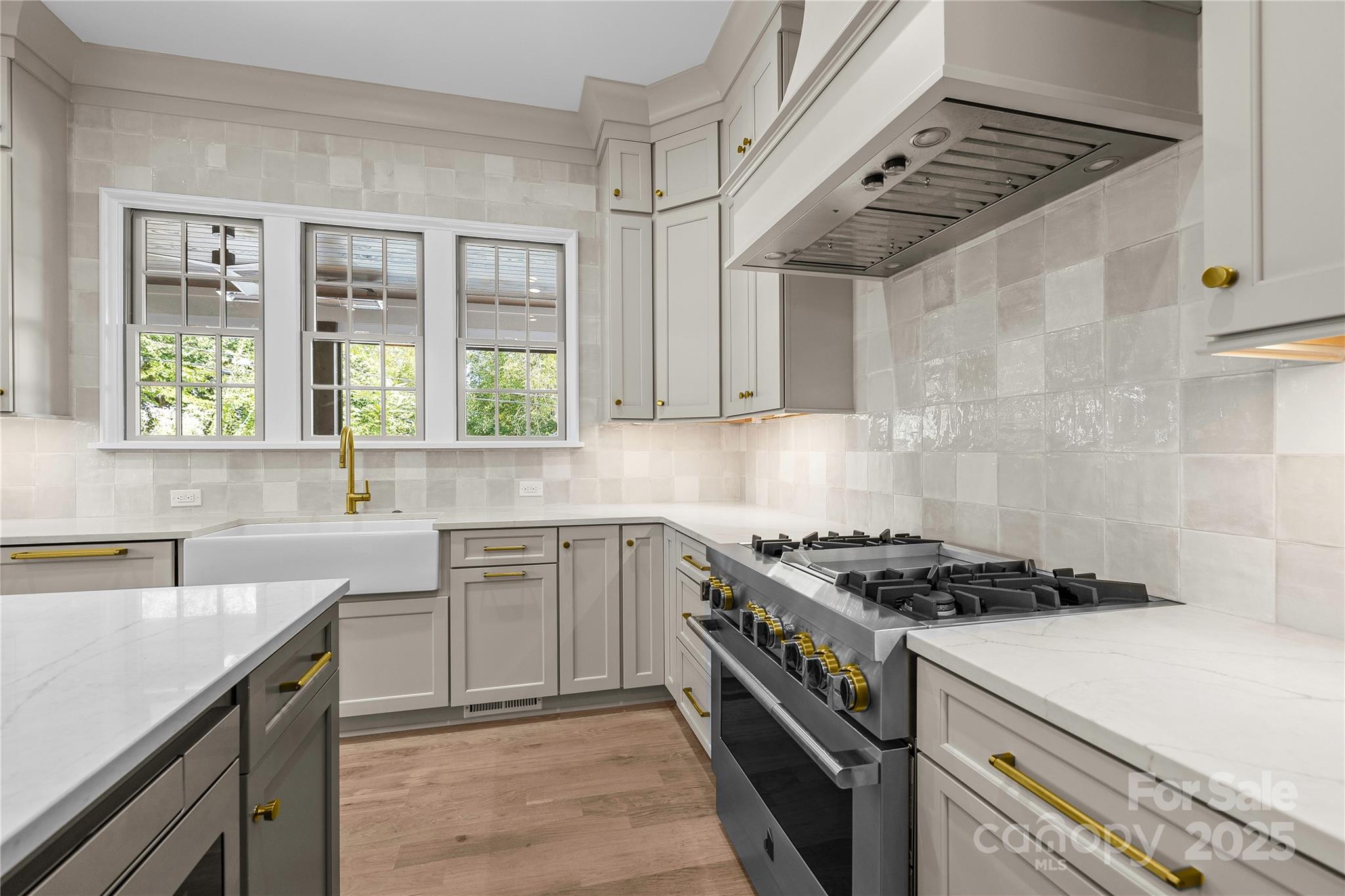 1233 Reece Road Charlotte, NC 28209 - Photo 11 of 48 a kitchen with stainless steel appliances a sink dishwasher stove and white cabinets