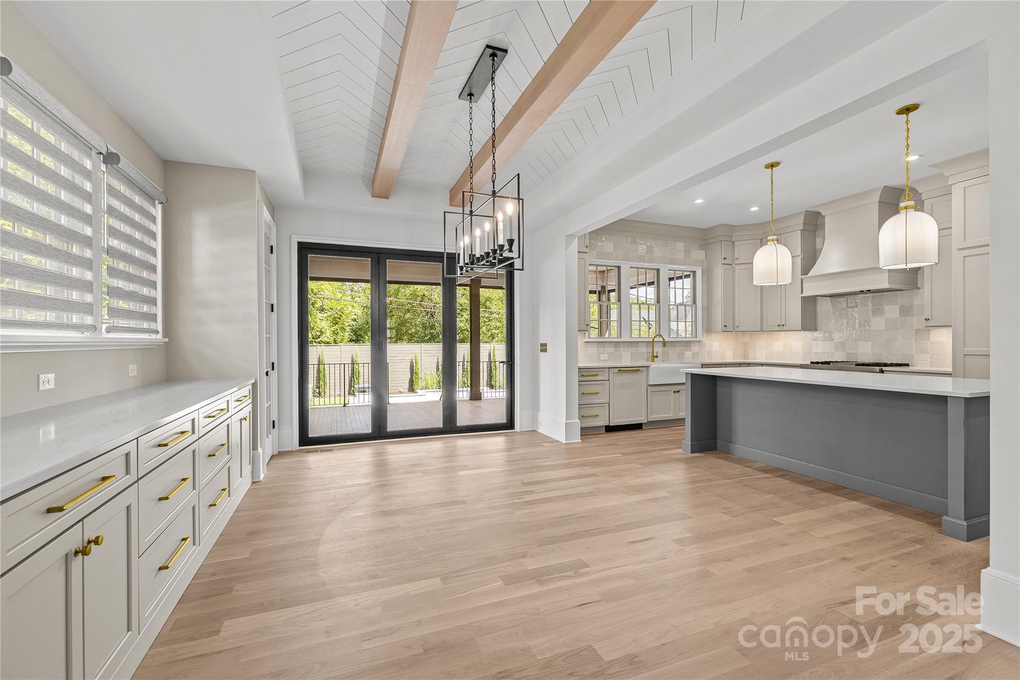 1233 Reece Road Charlotte, NC 28209 - Photo 12 of 48 a large kitchen with granite countertop a large counter top a sink stainless steel appliances and cabinets