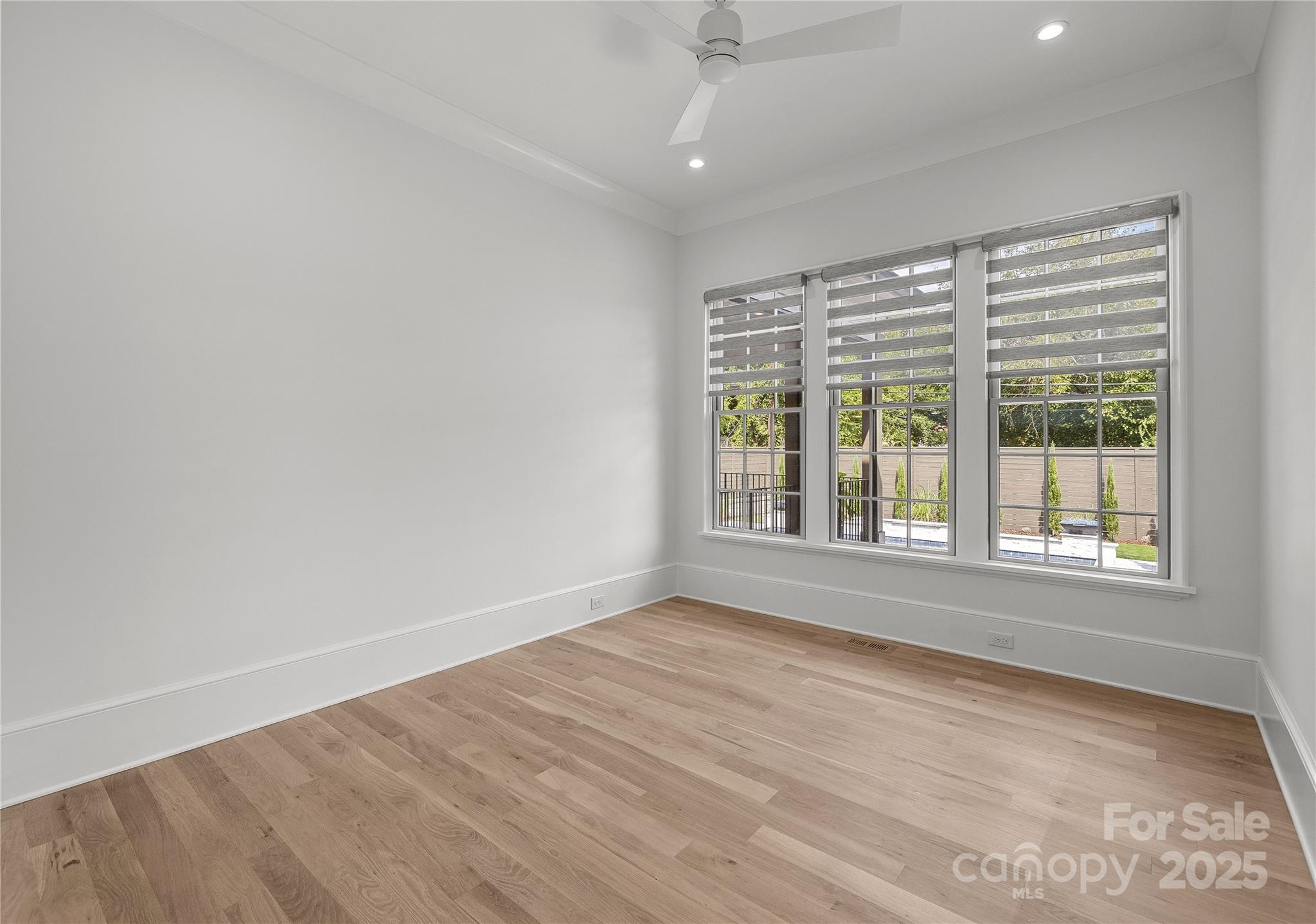 1233 Reece Road Charlotte, NC 28209 - Photo 14 of 48 an empty room with wooden floor and windows
