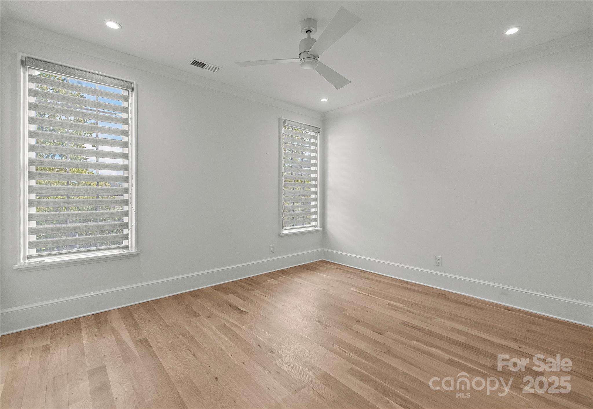 1233 Reece Road Charlotte, NC 28209 - Photo 28 of 48 a view of an empty room with wooden floor and a window