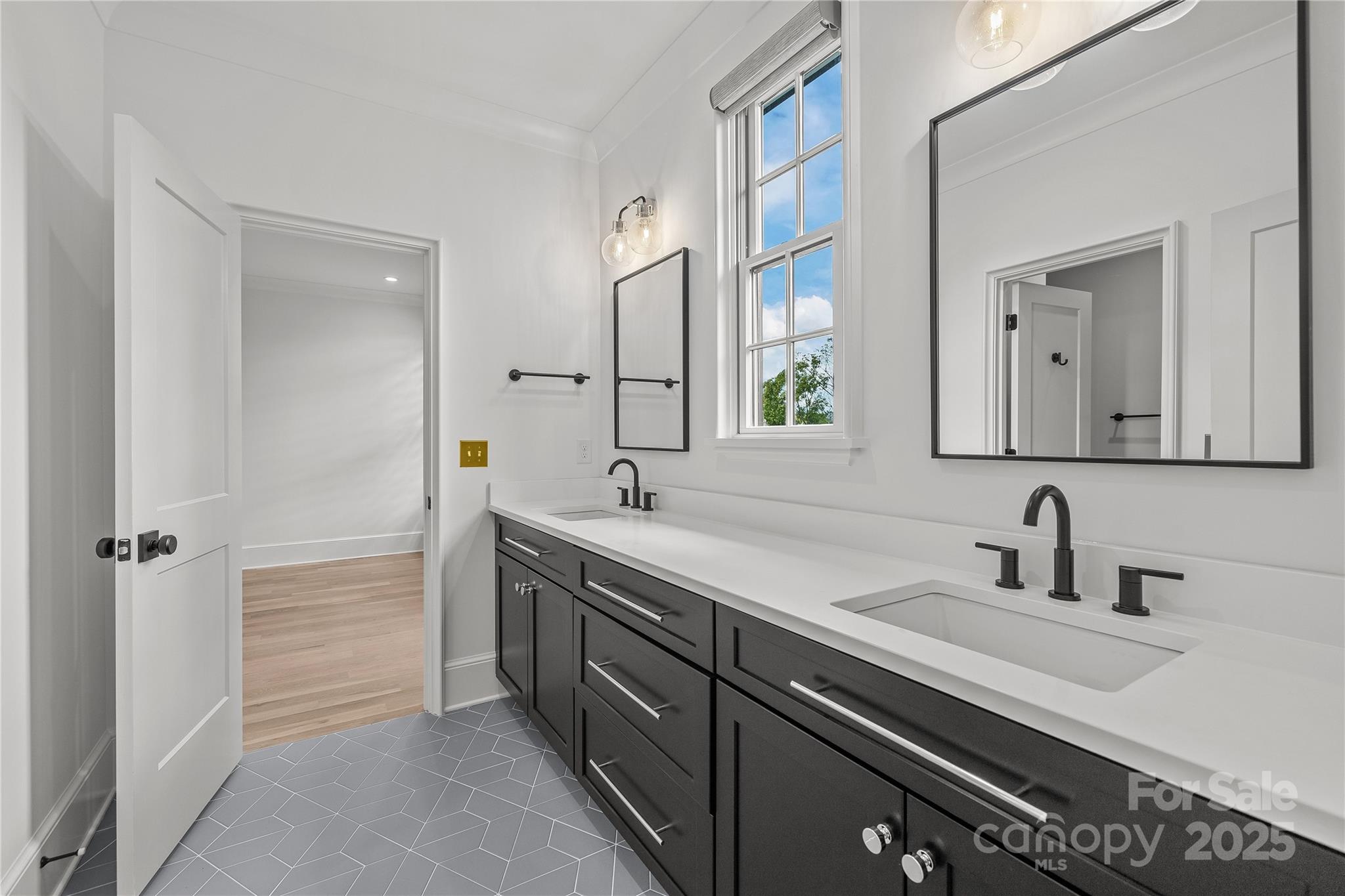 1233 Reece Road Charlotte, NC 28209 - Photo 29 of 48 a bathroom with a double vanity sink and mirror