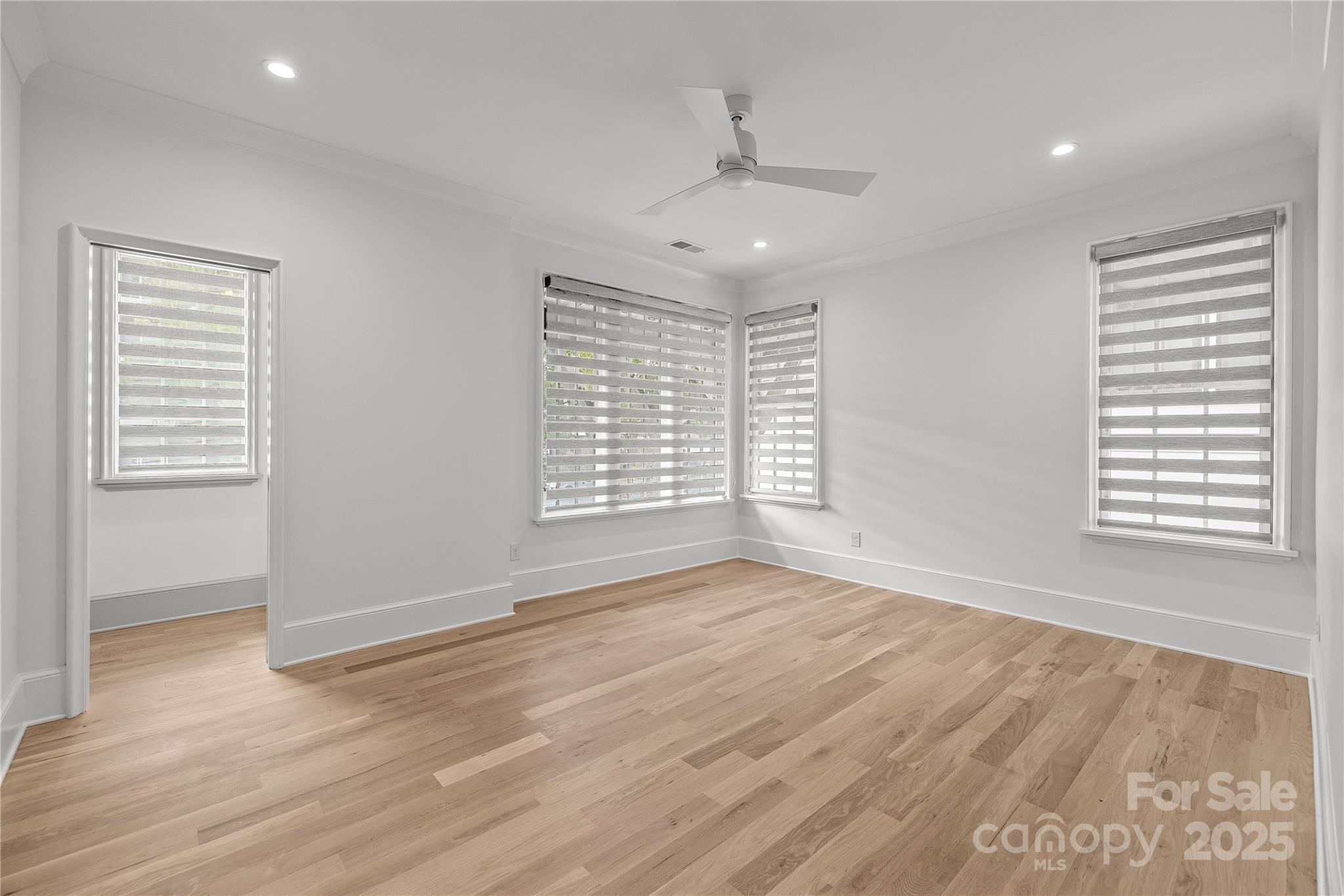 1233 Reece Road Charlotte, NC 28209 - Photo 32 of 48 a view of an empty room with wooden floor and a window