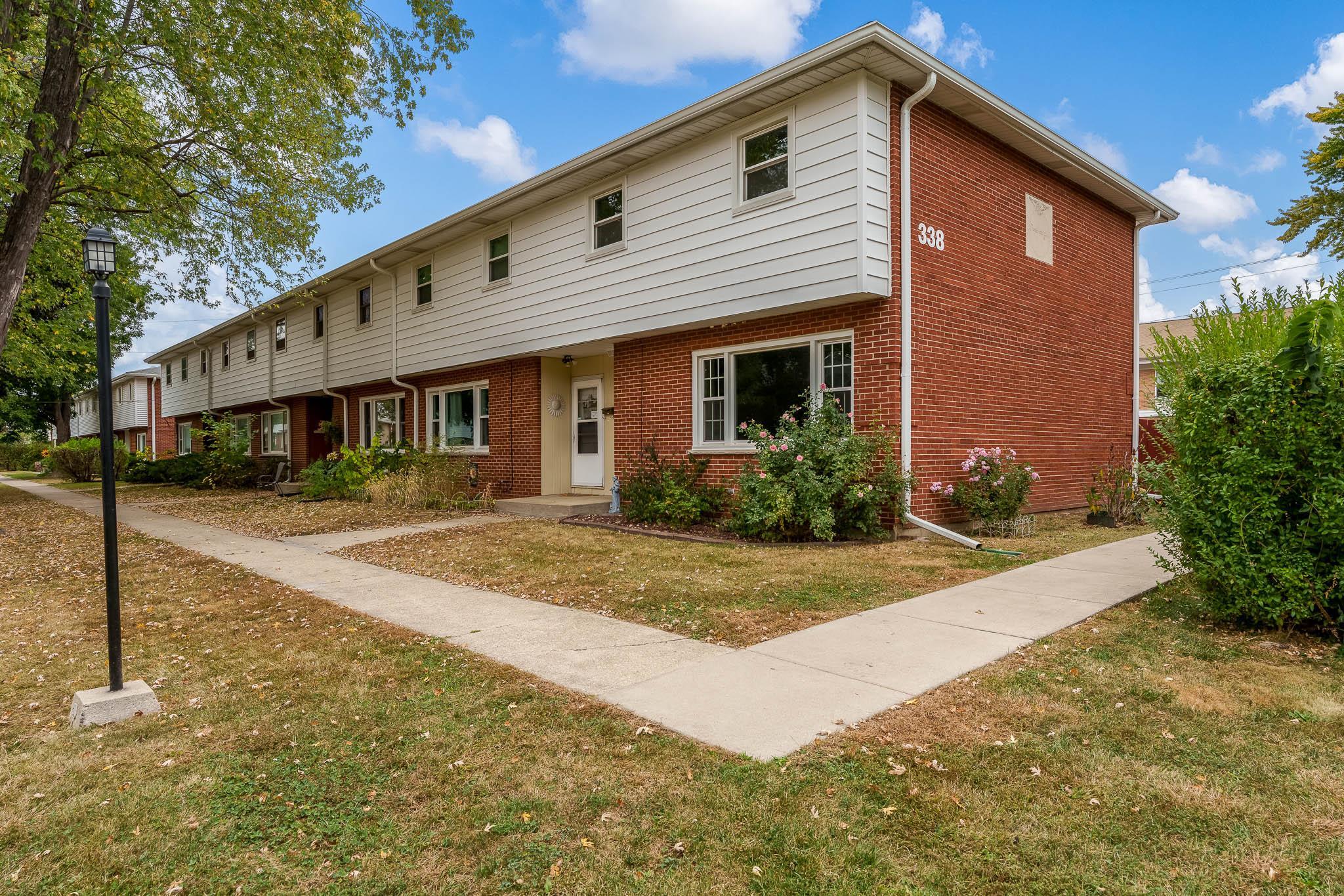 338 Northway Park Road, Unit 6 Machesney Park, IL 61115 - Photo 1 of 38 a front view of a house with yard garage and outdoor seating