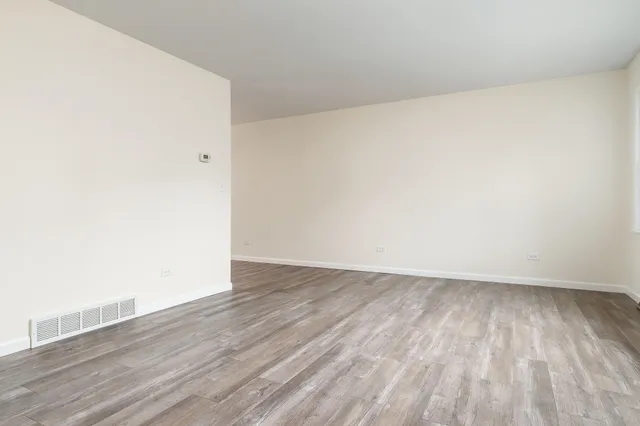 an empty room with wooden floor