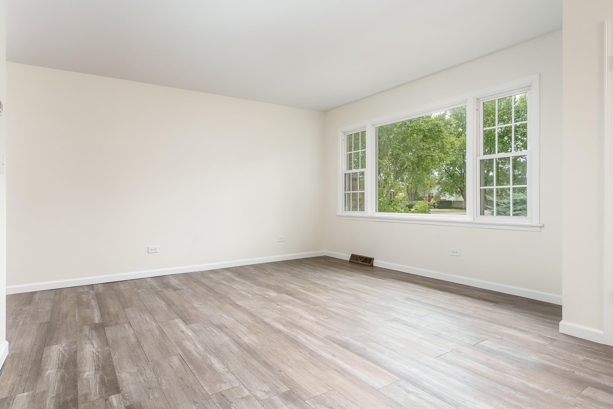 338 Northway Park Road, Unit 6 Machesney Park, IL 61115 - Photo 12 of 38 an empty room with wooden floor and windows