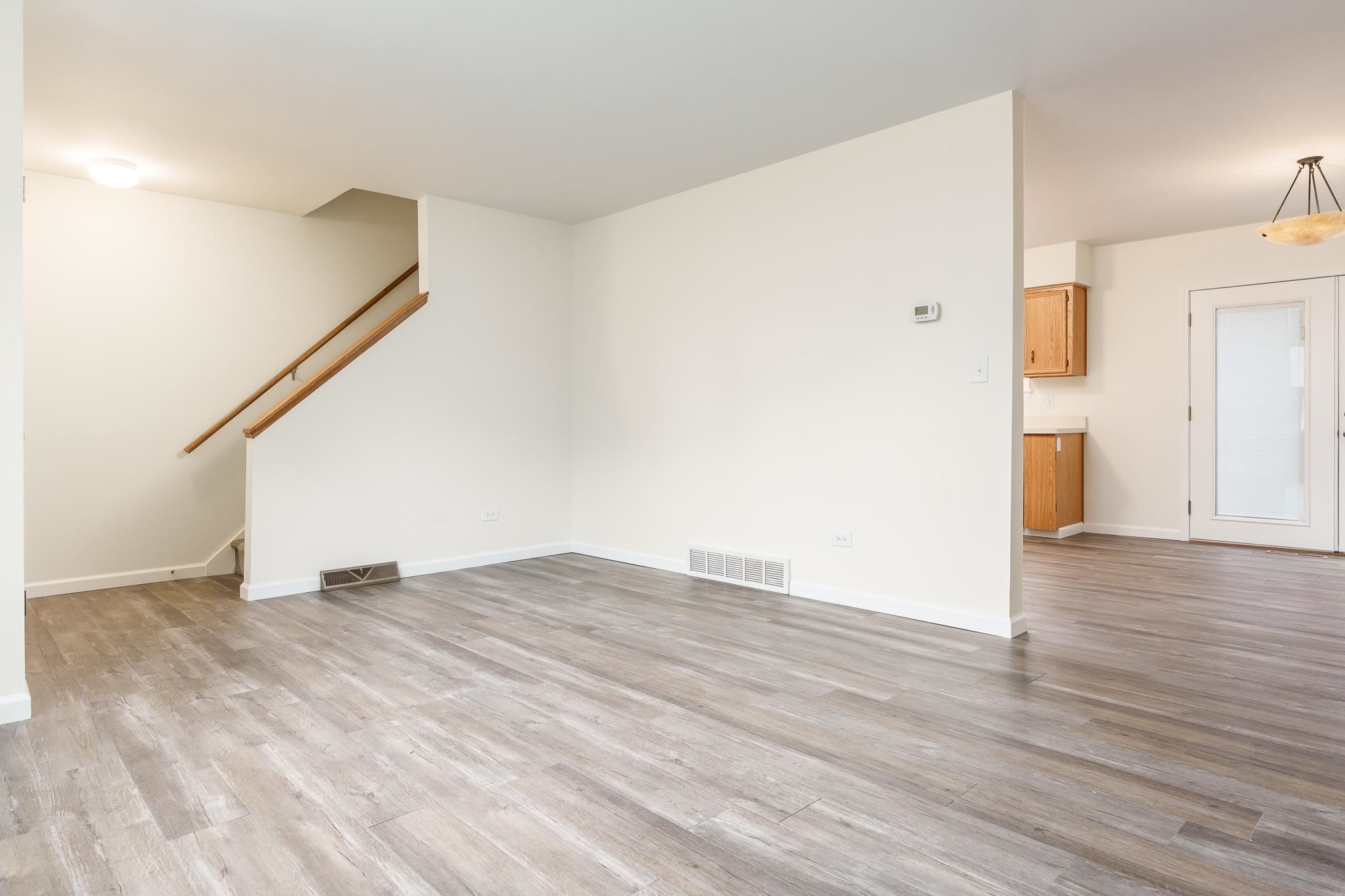 338 Northway Park Road, Unit 6 Machesney Park, IL 61115 - Photo 13 of 38 a view of an empty room with wooden floor