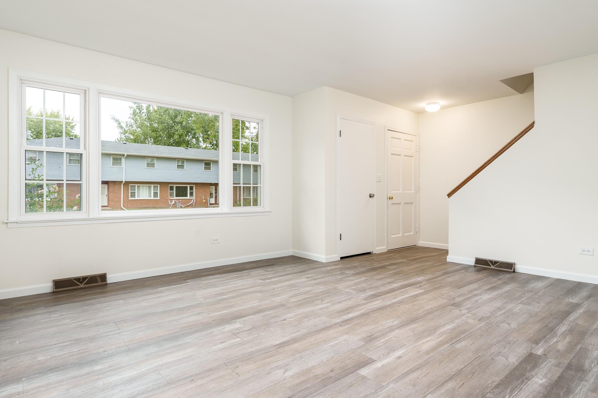 338 Northway Park Road, Unit 6 Machesney Park, IL 61115 - Photo 14 of 38 an empty room with wooden floor and windows