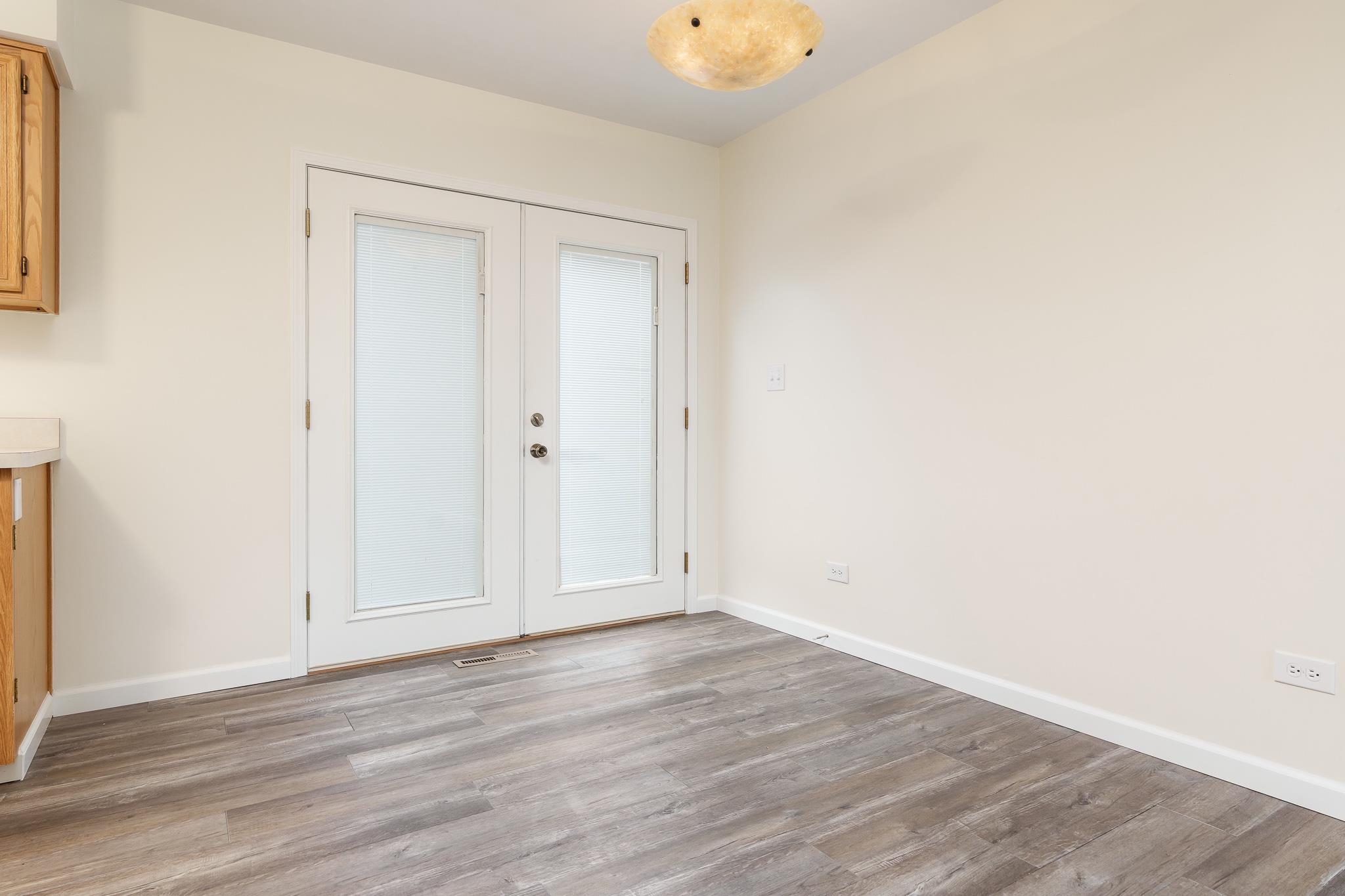 338 Northway Park Road, Unit 6 Machesney Park, IL 61115 - Photo 16 of 38 a view of an empty room with wooden floor