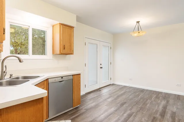 a kitchen with a sink cabinets and a wooden floor