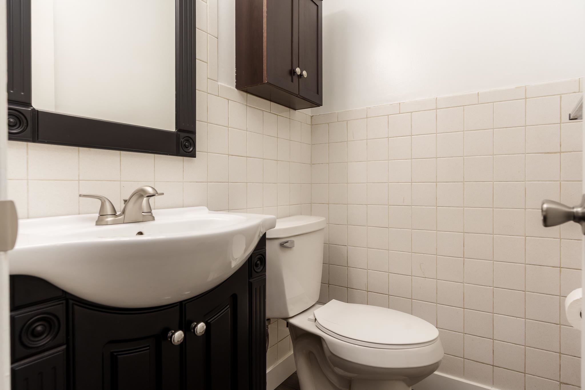 338 Northway Park Road, Unit 6 Machesney Park, IL 61115 - Photo 23 of 38 a bathroom with a sink a toilet and mirror