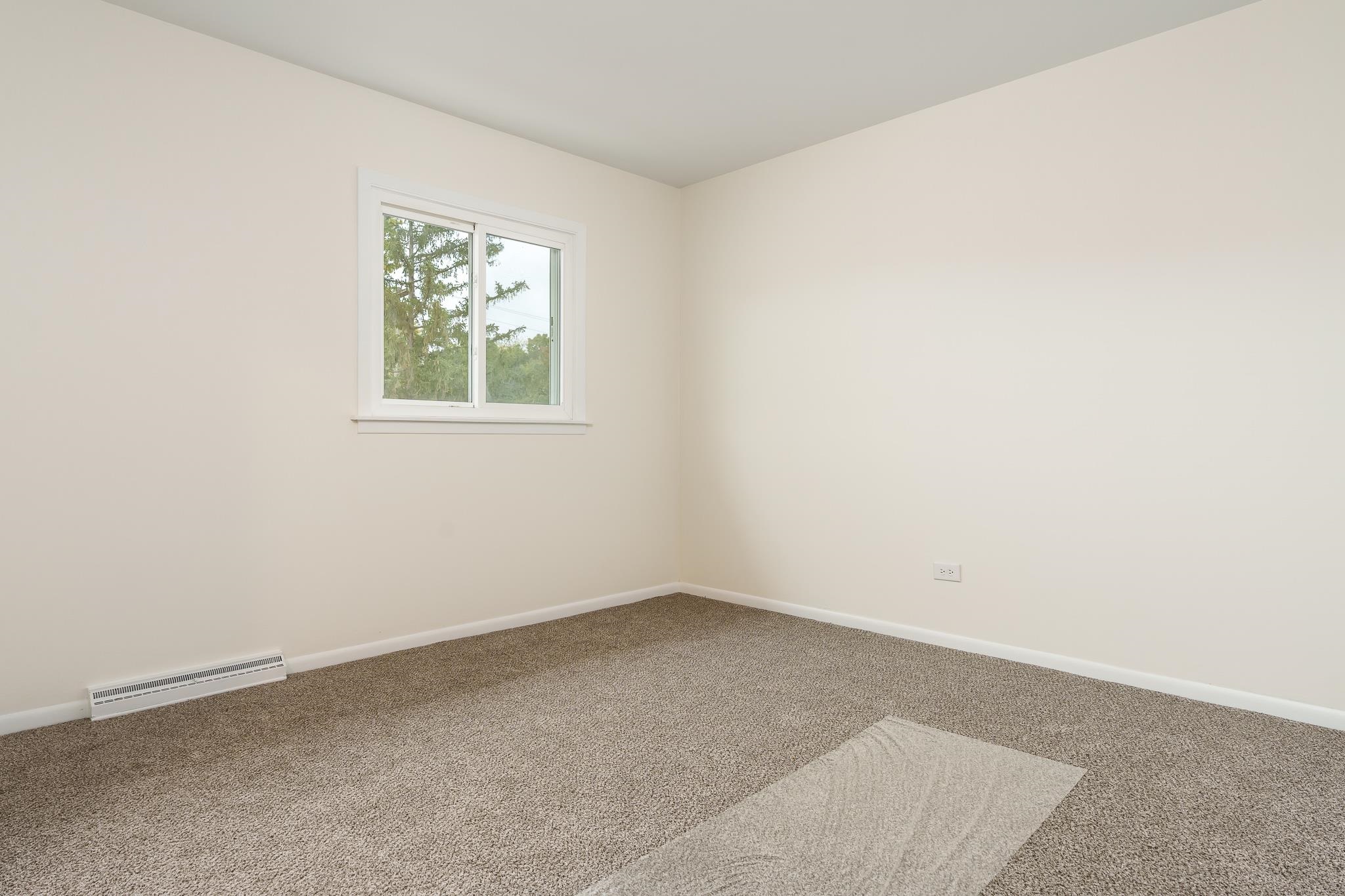 338 Northway Park Road, Unit 6 Machesney Park, IL 61115 - Photo 26 of 38 an empty room with a window