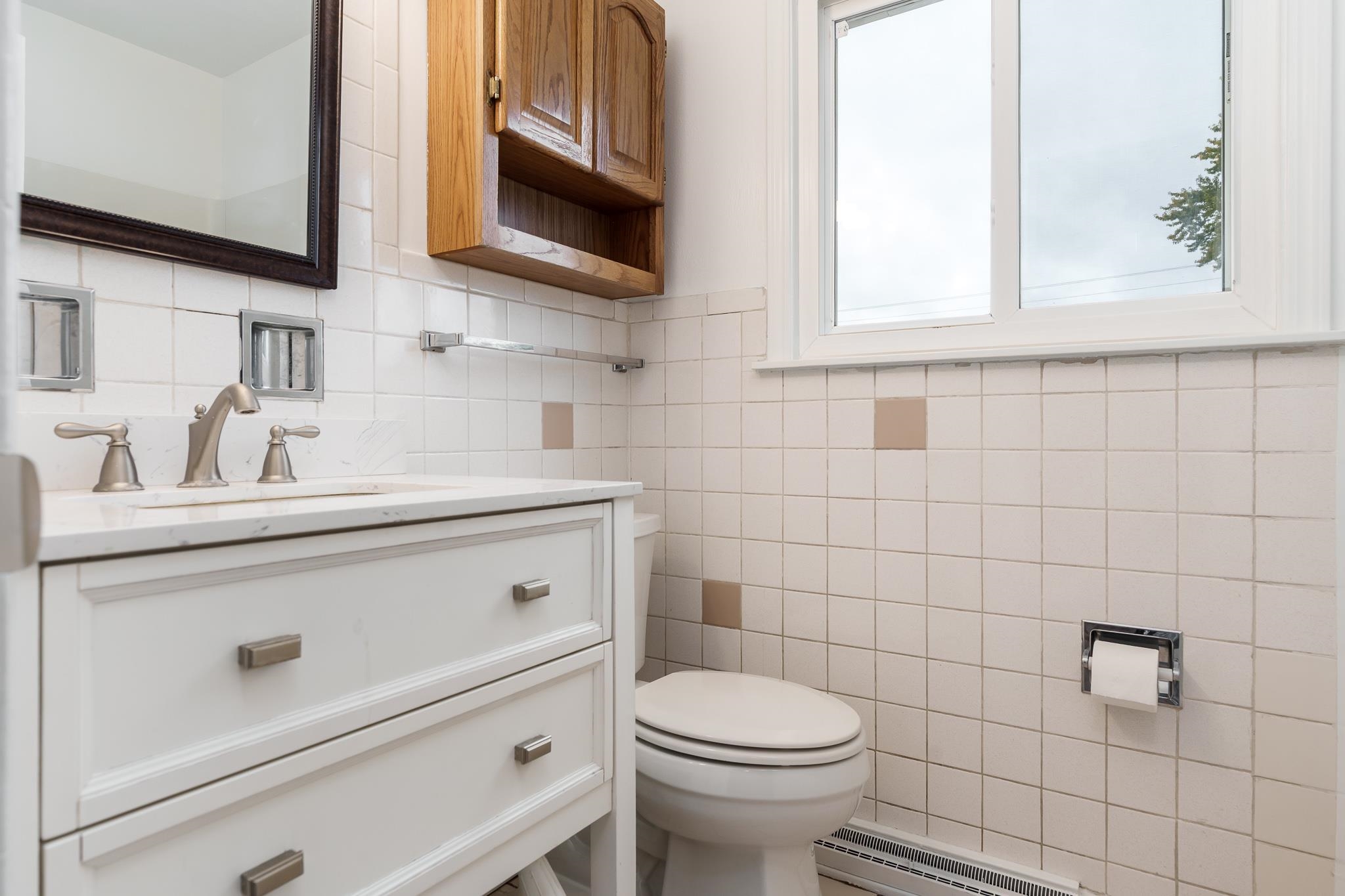 338 Northway Park Road, Unit 6 Machesney Park, IL 61115 - Photo 29 of 38 a bathroom with a sink a toilet and a mirror
