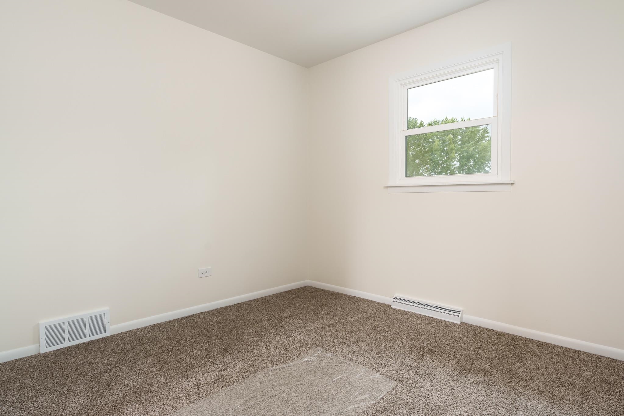 338 Northway Park Road, Unit 6 Machesney Park, IL 61115 - Photo 33 of 38 an empty room with a window