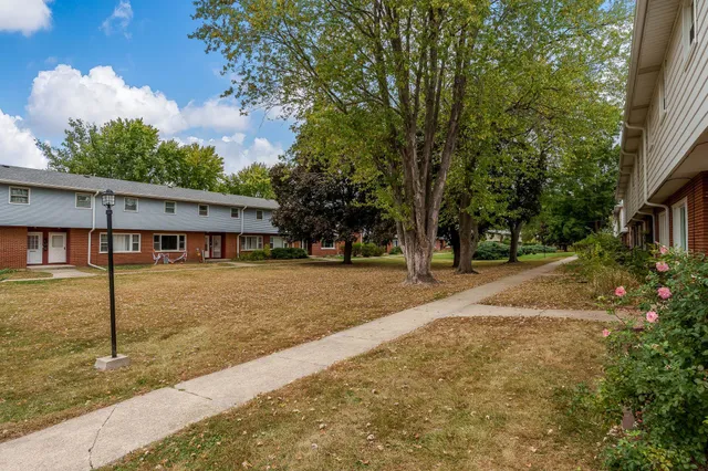 a view of a house with backyard and trees
