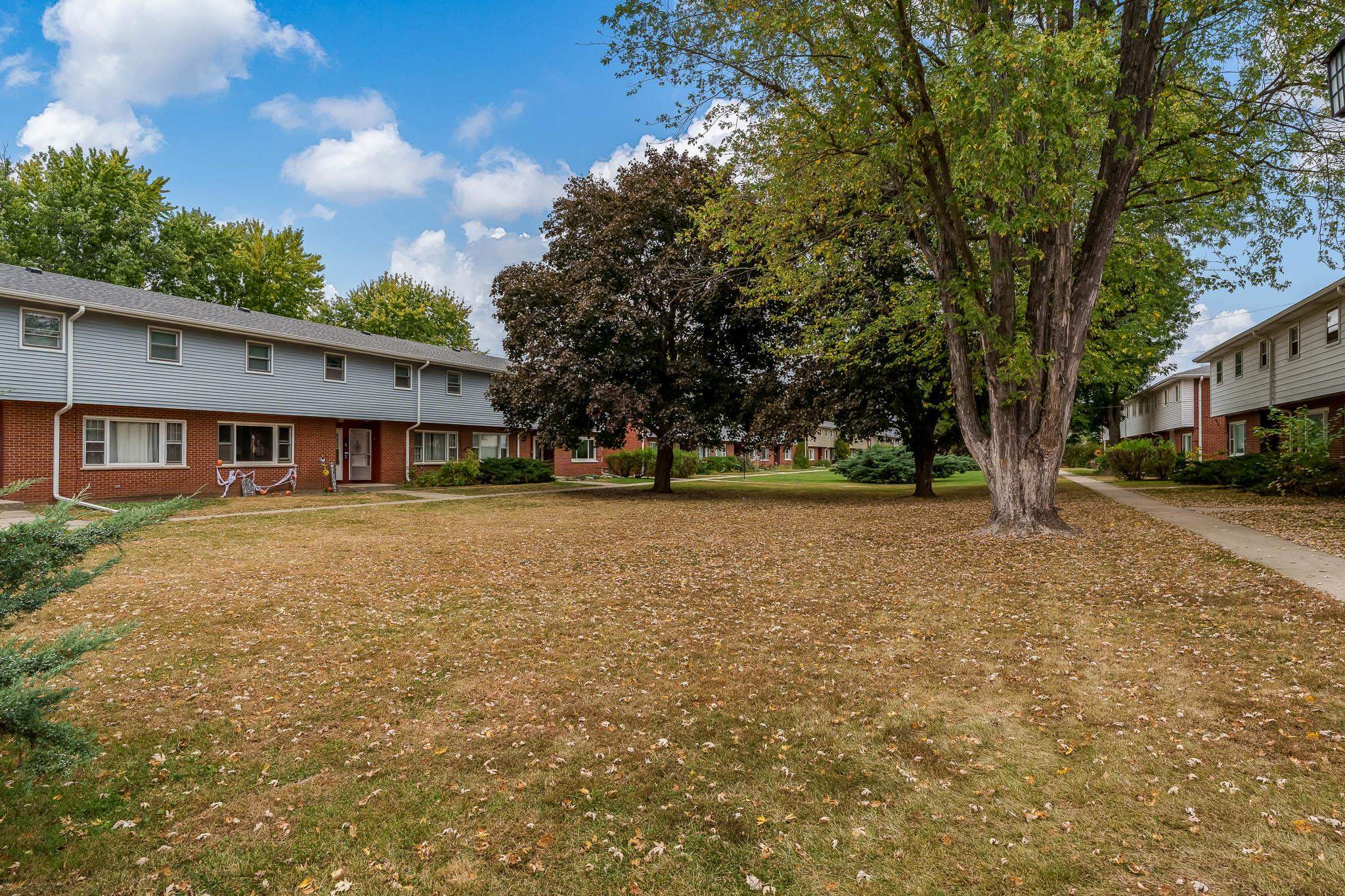 338 Northway Park Road, Unit 6 Machesney Park, IL 61115 - Photo 5 of 38 a front view of a house with a yard and trees