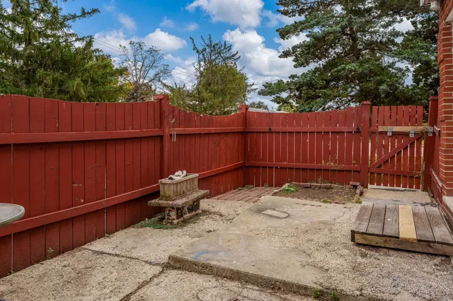 a backyard of a house with table and chairs