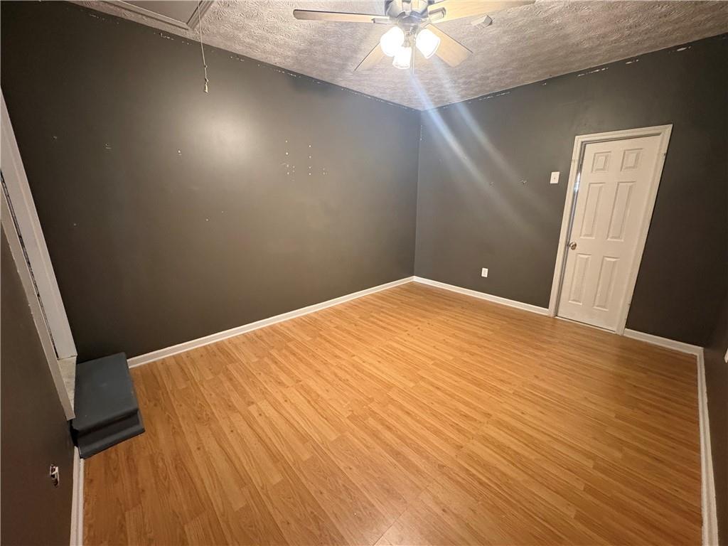 298 Little Street White, GA 30184 - Photo 16 of 23 a view of a big room with wooden floor