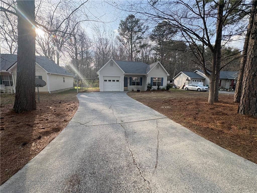 298 Little Street White, GA 30184 - Photo 2 of 23 a front view of a house with a yard and garage