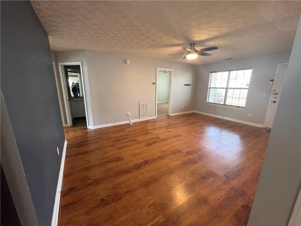 298 Little Street White, GA 30184 - Photo 4 of 23 a view of empty room with window and wooden floor