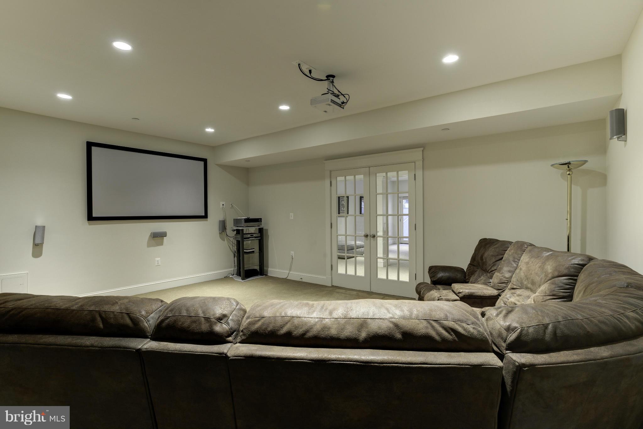 8007 Custer Road Bethesda, MD 20814 - Photo 23 of 25 a living room with furniture and a flat screen tv