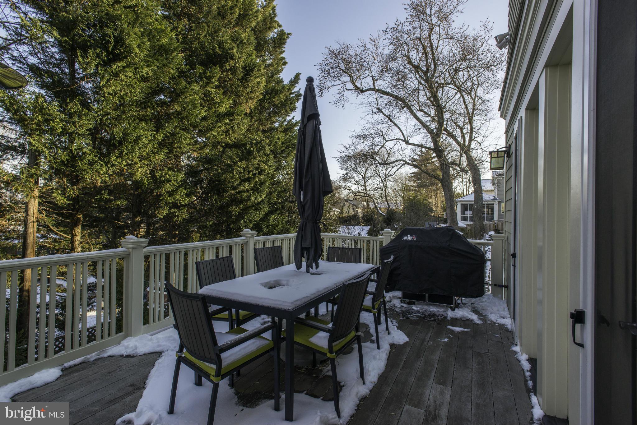 8007 Custer Road Bethesda, MD 20814 - Photo 24 of 25 a view of balcony with table and chairs and wooden floor