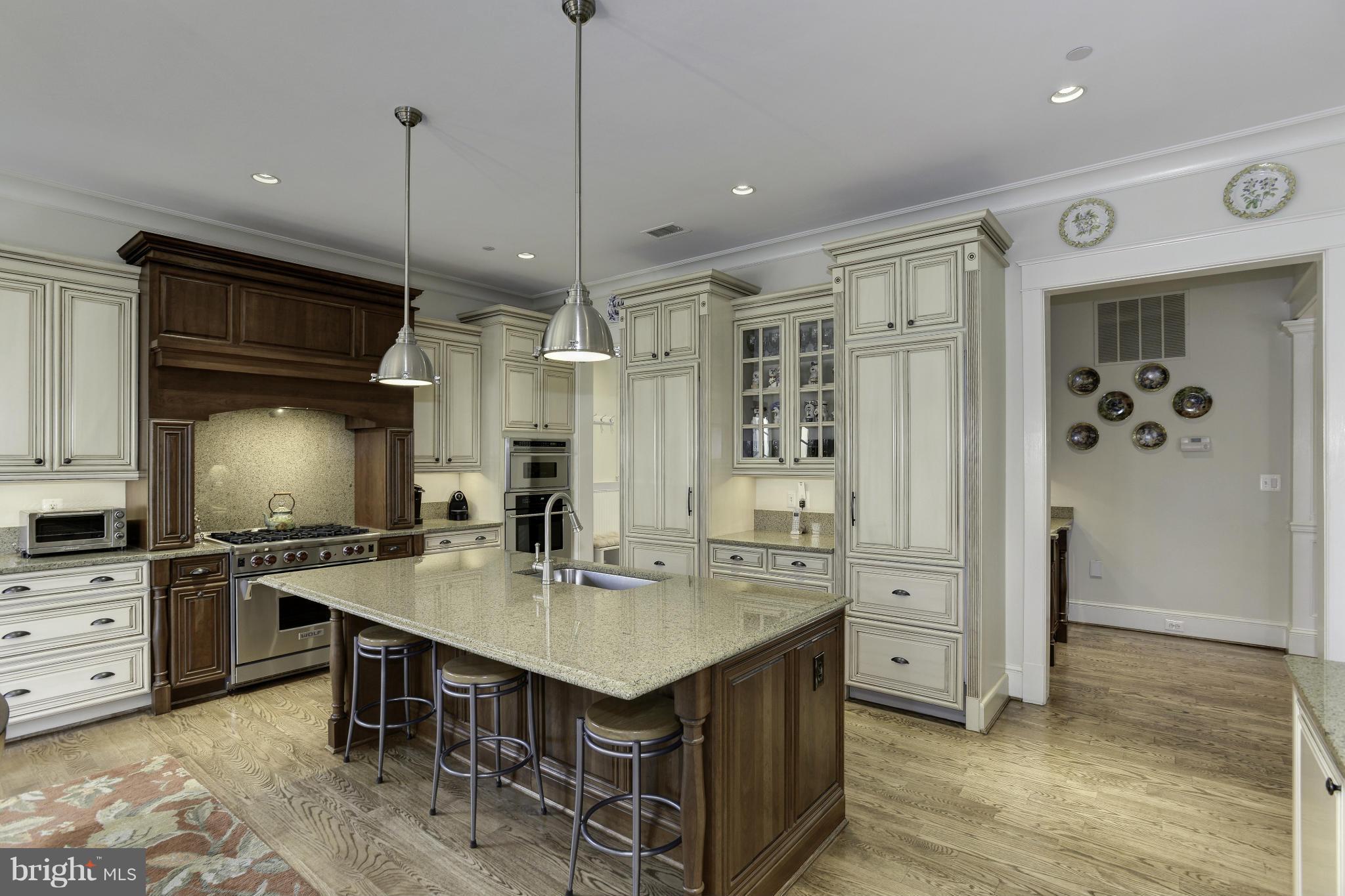 8007 Custer Road Bethesda, MD 20814 - Photo 7 of 25 a kitchen with stainless steel appliances granite countertop a sink a stove and a refrigerator