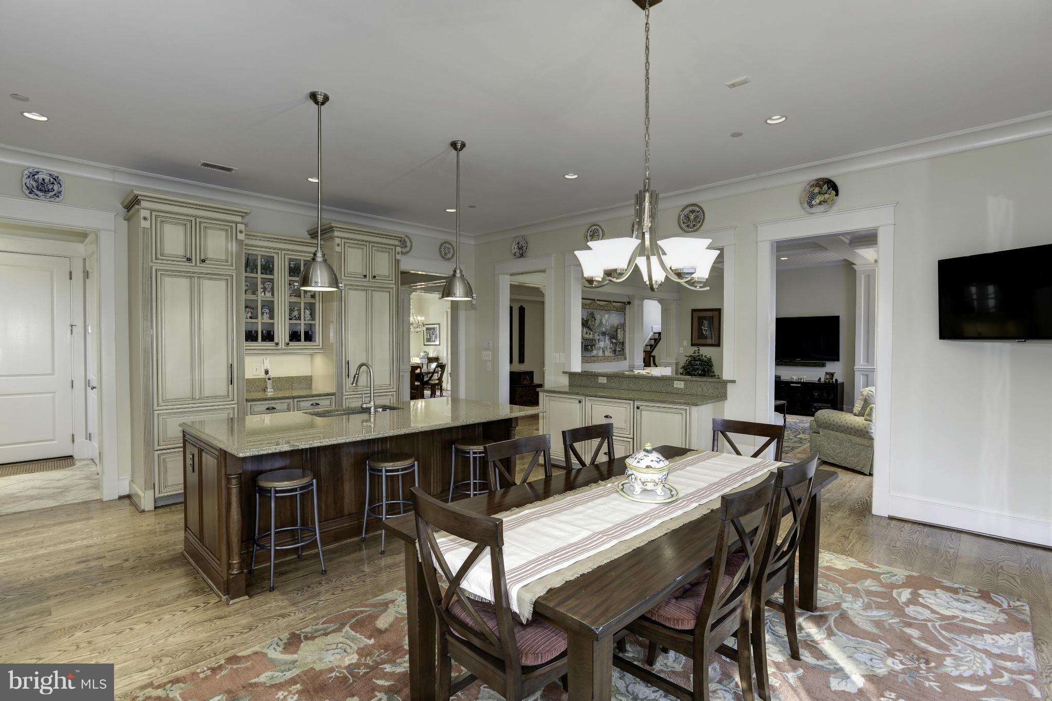 8007 Custer Road Bethesda, MD 20814 - Photo 9 of 25 a large kitchen with a table and chairs in it