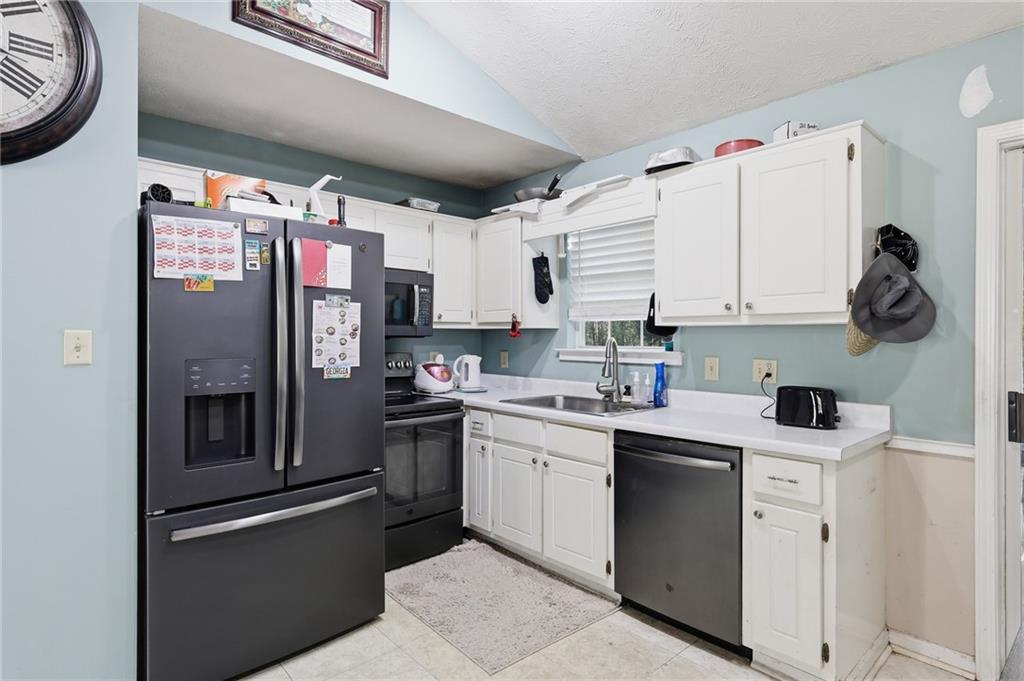 211 Brooks Lane Winder, GA 30680 - Photo 13 of 27 a kitchen with stainless steel appliances granite countertop a refrigerator and a stove
