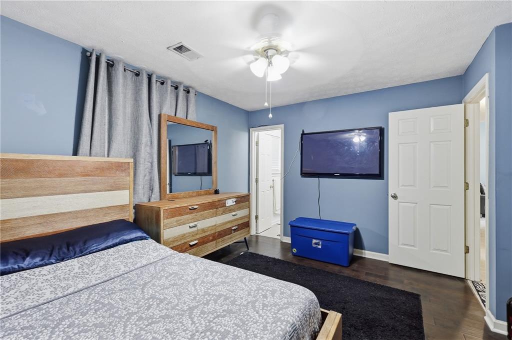 211 Brooks Lane Winder, GA 30680 - Photo 17 of 27 a bedroom with a bed and a chandelier