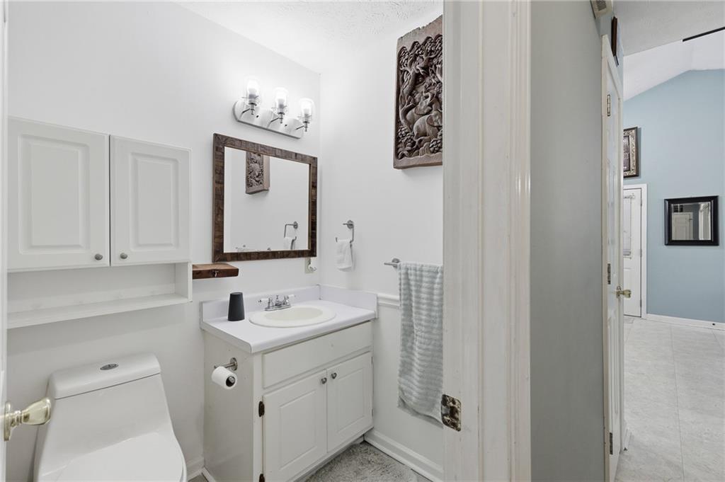 211 Brooks Lane Winder, GA 30680 - Photo 22 of 27 a bathroom with a sink a toilet and mirror