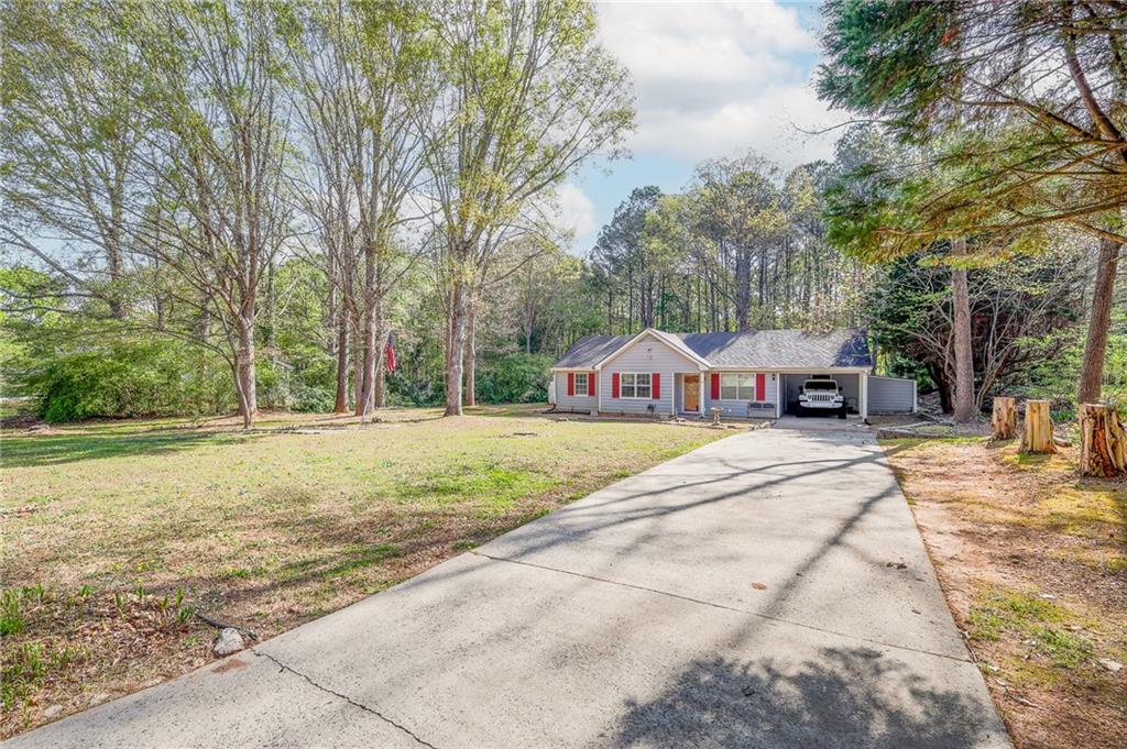 211 Brooks Lane Winder, GA 30680 - Photo 5 of 27 a house with trees in front of it