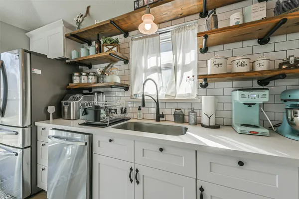 a kitchen with stainless steel appliances granite countertop a stove and a microwave