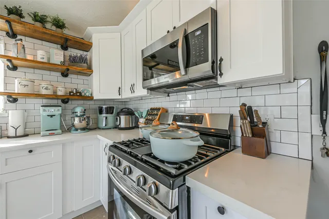 a view of an empty room with a fireplace