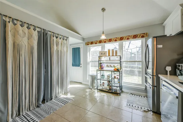 a kitchen with stainless steel appliances granite countertop a stove top oven a refrigerator a sink and dishwasher