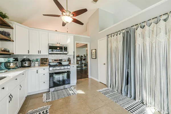 a kitchen with stainless steel appliances granite countertop a stove cabinets and a sink