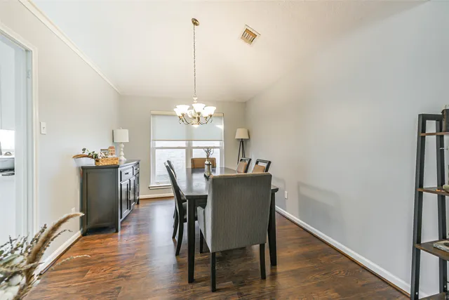 a view of a dining room with furniture and chandelier