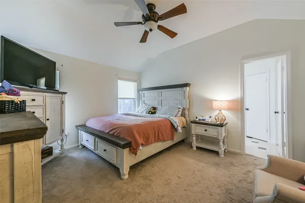 a bedroom with a bed and a dresser