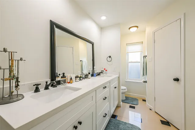 a bathroom with a double vanity sink mirror and double