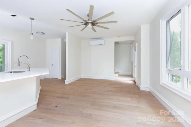 a view of a kitchen with a sink and a window