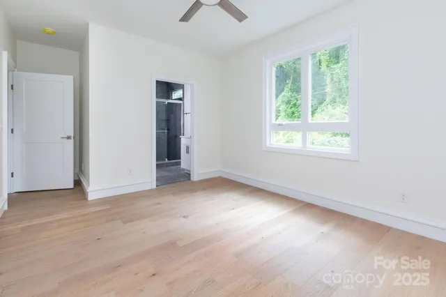 an empty room with windows and closet