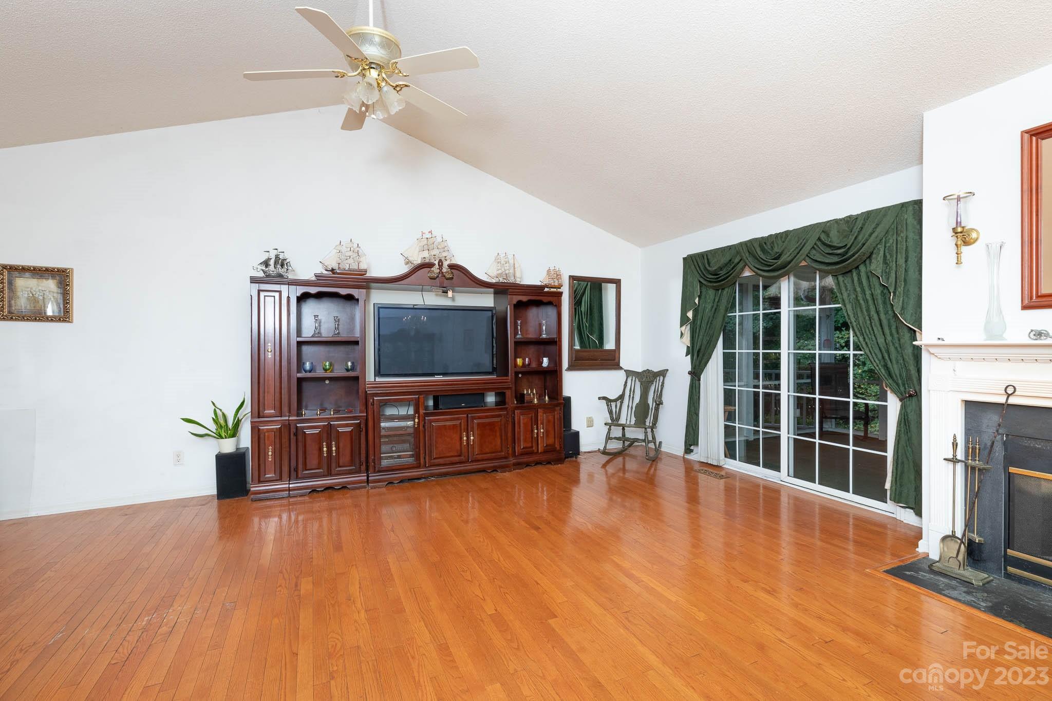 1598 Glenway Road Clover, SC 29710 - Photo 22 of 36 a living room with furniture a flat screen tv and a large window