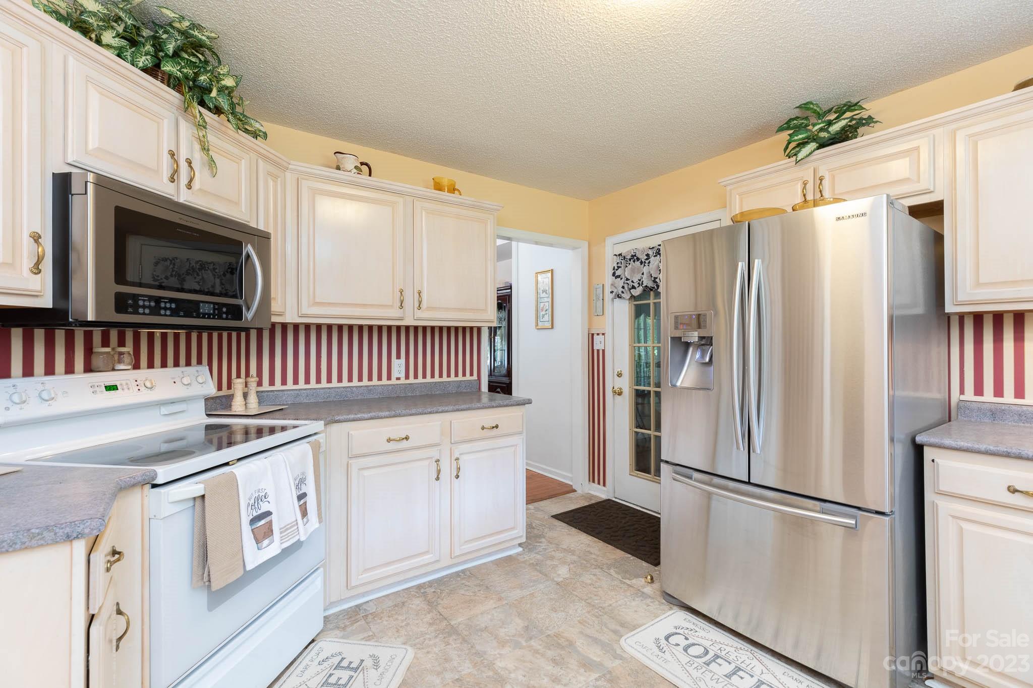 1598 Glenway Road Clover, SC 29710 - Photo 25 of 36 a kitchen with stainless steel appliances white cabinets and a refrigerator