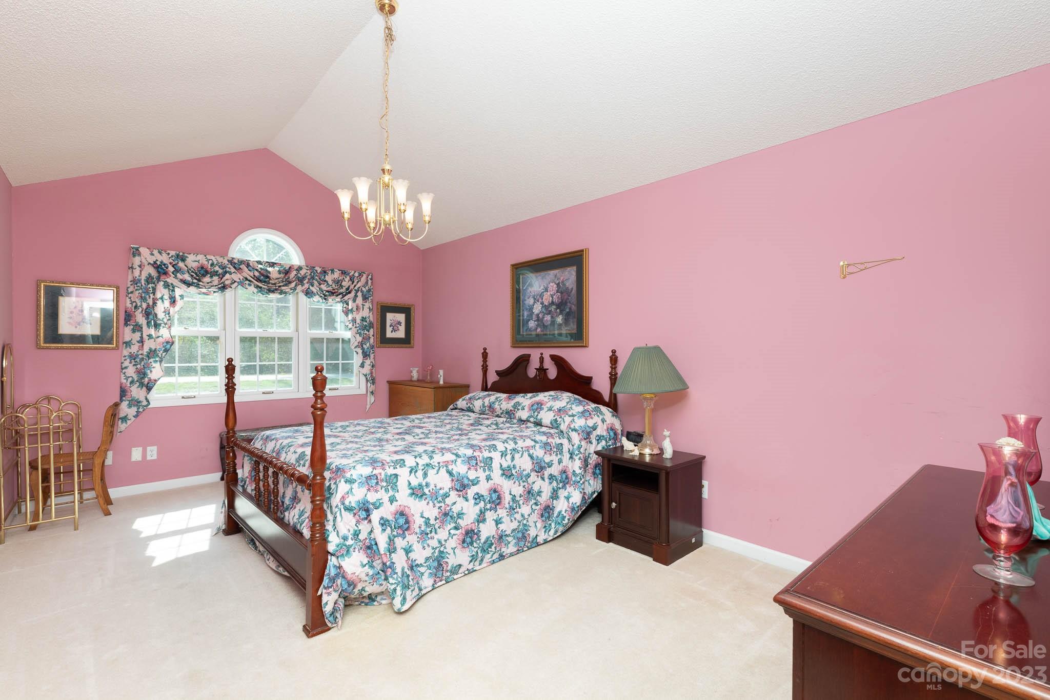 1598 Glenway Road Clover, SC 29710 - Photo 34 of 36 a bedroom with a bed and a chandelier