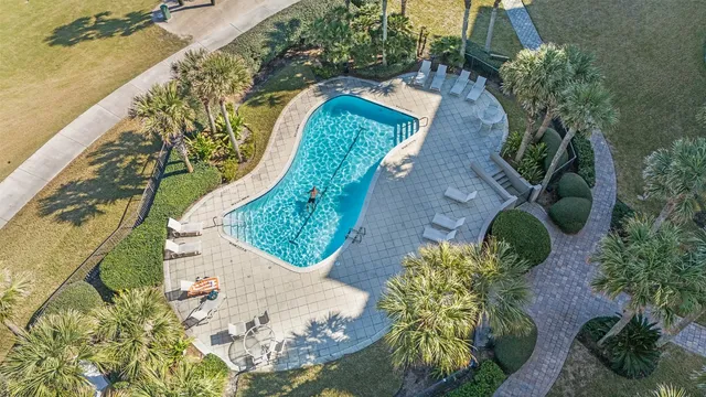an aerial view of a house with a yard and a fountain