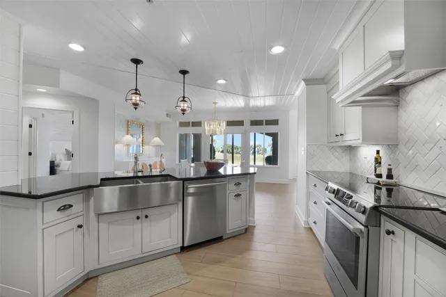 a large kitchen with stainless steel appliances lots of counter space sink and cabinets